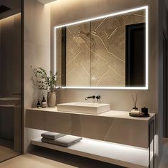 a bathroom with a sink, mirror and lights on the wall above it's counter