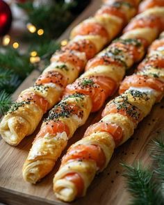 some very tasty looking food on a wooden cutting board with christmas decorations in the background