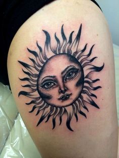 a woman's thigh with a sun tattoo on it