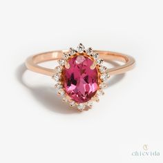 DetailsMaterial: 14k/18k gold Color Options: Yellow Gold, White Gold, Rose Gold, ★ Center StonePink Tourmaline, OvalSize: 5X7 mmApprox Weight (Ct): 0.96★ Accent StonesDiamond RoundSize: 1.1 mm * 12 No.s , 1.5 mm * 4 Nos.Approx Weight (Ct): 0.15★ Band Width: 1.3 mm★ Ring Height: 7 mm Pink Gemstone Engagement Rings, Tourmaline Wedding Ring, Pink Tourmaline Engagement Ring, Pink Tourmaline Jewelry, October Birthstone Ring, Unique Promise Rings, Unique Rings Vintage, October Birthstone Rings, Pink Tourmaline Ring