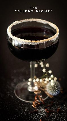 a glass filled with liquid sitting on top of a table