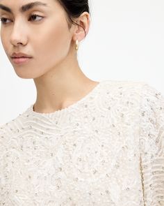 Sparkle all summer long. The Ivy Top has a flowing shape that boasts a round neck and delicately draped sleeves. It's relaxed fitting and cropped to create an elevated structure. Elegant gems, sequins and bead embellishments are a luxe touch. Dress this up with flowing maxi skirts or fitted pants (don't forget a statement metallic heel, now that's a look).  This top is designed to a relaxed fit Keyhole button closure at the back of the neck Round neck Short sleeves Cropped Draped sleeves and hem Draped Sleeves, Fitted Pants, Drape Sleeves, The Ivy, Metallic Heels, Maxi Skirts, Cropped Top, All Saints, Denim Shop