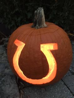 a pumpkin with the letter u carved into it