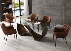 a glass table with brown chairs around it