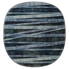 an oval rug with black and blue stripes on it, in the shape of a circle