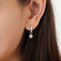 These celestial moon and star cz encrusted earrings are ideal for your favorite star gazer. She will love to wear these comfortable dangle hoop earrings that feature both a moon and star completely encrusted in glittering clear cubic zirconia stones. A beautiful and unique way to display her love for starring at the night sky. These moon and star earrings for kids are sure to be a hit with her friends too. Great gift for birthdays and holidays. A gift box is included. Celestial Style Huggie Earrings With Star Charm, Celestial Hoop Earrings With Star Charm For Everyday, Everyday Celestial Star Earrings, Sterling Silver Huggie Earrings With Dangling Charms For Everyday, Everyday Sterling Silver Huggie Earrings With Dangling Charms, Celestial Star Charm Earrings For Everyday, Celestial Star-shaped Huggie Earrings With Star Charm, Celestial Small Hoop Earrings With Star Charm, Moon Charm Huggie Earrings