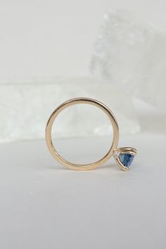 Blue sapphires come in all shades and clarity - this oval-shaped gem is wonderfully clear and sparking, with a rich, deep shade of blue that can change to more purple in different lighting. We've set this sapphire in a simple, airy prong with two tiny white diamonds under it. The overall effect is one of whimsy and delicacy, but this ring will be an heirloom for generations. - 1.45ct sapphire﻿- 0.03ctw diamonds﻿- 14k recycled yellow gold﻿- 2mm band﻿- High polish finish ﻿This ring ships immediate Cleaning Stone, Hanging Necklaces, Shade Of Blue, Different Lighting, Blue Sapphire Rings, White Diamonds, Diamond White, Prong Setting, Shades Of Blue