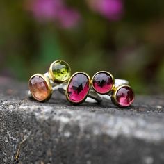 A carved, faceted Sterling Silver band is adorned with a fabulous Tourmaline encased in either 14k or 22k yellow gold. These rings were meant for the pinky finger. Most peoples pinky fingers are between a 2.5-4. Get ready to up your tea game! You’ll love this treasure for everything from bridal jewelry to daily wear. Not exactly what you're looking for? Check out our customs page. Each ring is one-of-a-kind and handmade in our Boulder, Colorado jewelry studio. Stackable Tourmaline Jewelry For Anniversary, Unique Faceted Yellow Gold Ring, Tourmaline Multi-stone Rings As Gift, Multi-stone Tourmaline Rings As A Gift, Gold Tourmaline Gemstone Rings, Formal Tourmaline Rings With Bezel Setting, Gold Tourmaline Rings, Formal Tourmaline Ring With Bezel Setting, Stackable Tourmaline Rings Fine Jewelry