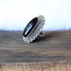 Black onyx ring, Sterling Silver ring, cocktail ring, alternative engagement ring, black onyx jewelry, Valentine's day jewelry, silver jewellery Description: Be assured that the product you order is MADE JUST FOR YOU and is not a mass produced item. The gemstone is a cushion shaped BLACK ONYX The rest of the ring is made from 925 STERLING SILVER i.e 92.5% pure silver. And it DOESN'T HAVE ANY LEAD OR NICKEL. I make more than 50 DIFFERENT GEMSTONES. If you want other gemstones, Please inbox me. I' Onyx Gemstone Open Ring Jewelry, Classic Onyx Ring Jewelry, Classic Onyx Ring, Unique Black Crystal Ring In Sterling Silver, Unique Black Sterling Silver Rings, Handmade Black Crystal Ring In Sterling Silver, Elegant Adjustable Onyx Rings, Handmade Black Open Ring Jewelry, Black Sterling Silver Metal Ring