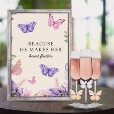 there are two glasses of wine next to a card that says because he makes her heart flutterer