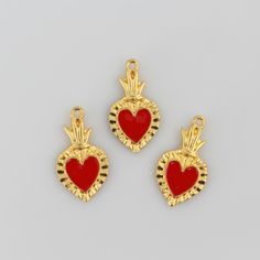 Sacred Heart Ex Voto charms that are a shiny gold color with red enamel detail. Quantity: Sold in packages of three (3) piecesSize: 1-1/16" long x 9/16" wide (27mm x 15mm)Material: Zinc based alloy, red enamel. Made in China.Important Note: Color and size may vary slightly. All of our products are lead and cadmium-free, and nickel-safe. As they contain small parts, all items are for adult jewelry/craft making use only, not intended for children under the age of 15. Red Enamel Jewelry With Charms, Red Charms For Valentine's Day, Red Valentine's Day Gift Charms, Red Enamel Jewelry For Valentine's Day, Red Charms For Valentine's Day Gift, Sacred Heart Of Jesus, Heart Pendants, Heart Of Jesus, Craft Making