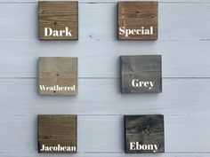 four wooden blocks with words on them that spell out the word dark, weathered, grey, and gloomy