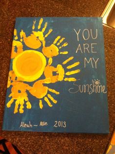 a handprinted canvas with the words you are my sunshine written in yellow and blue