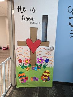 a door decorated with an image of a cross and flowers on the outside, says he is risen