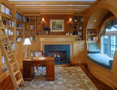 a living room filled with furniture and a fire place next to a book shelf full of books