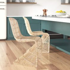 a bamboo chair sitting on top of a hard wood floor in a kitchen next to an island