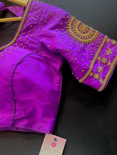 Purple Color Soft Silk Readymade Blouse with beautiful Handwork Work. Golden Color Beads and Sequence Work with beautiful tassels. Item : Readymade BlouseSize : 36 (Can be opened to Size 40)Length of the Blouse : 14 inches Length of the Sleeves : 10 inches Color : Purple Blouse Fabric : Soft Silk Lining : Yes, it is fully lined Padded or Non-Padded : PaddedClosure: Front Closure with hooks.Ready-to-Wear : YesDisclaimer - : -This is a Standard Size blouse. We do not guarantee perfect fit as every Luxury Purple Blouse Piece With Embroidered Border, Diwali Purple Dola Silk Blouse, Purple Art Silk Unstitched Blouse Piece, Purple Silk Self-design Blouse Piece, Unstitched Purple Cotton Silk Blouse Piece, Blouse Handwork, Readymade Saree, Padded Blouse, Saree Blouses