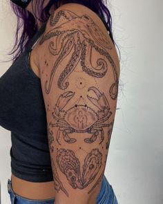 a woman's arm with an octopus tattoo on her left shoulder and the other half sleeve