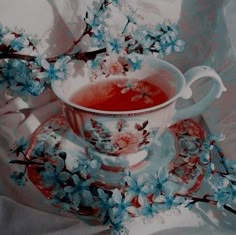 a painting of a tea cup and saucer with blue flowers