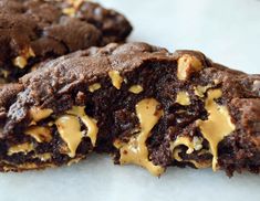 two chocolate cookies with peanut butter on top