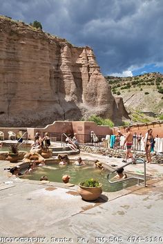 people are standing around in the hot springs