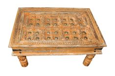 an old wooden table with carvings on it