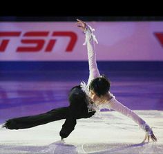 a man and woman skating on an ice rink