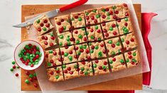 a cutting board topped with cookies and candy