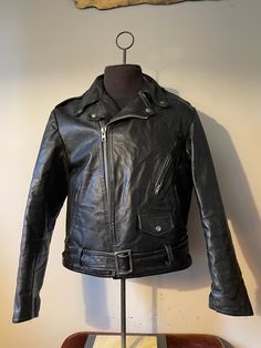 "Vintage Leather Jacket  - Biker style - 1960s vintage  - Buckle strap bottom belt  - Flared zipper sleeves  - Zipper/button pockets  - Buttoned Collar - Rare vintage Grail - Cropped style design  - Clix zipper  Size: L/M 24\" pit to pit  26\" shoulder to waist  25\" sleeve  Great vintage condition  No rips or holes  No stains" Retro Winter Biker Jacket With Zipper Closure, Retro Winter Outerwear For Biker Events, Vintage Black Outerwear With Zipper Closure, Retro Biker Jacket With Zipper For Biker Events, Retro Fitted Biker Jacket With Long Sleeves, Retro Fitted Long Sleeve Biker Jacket, Vintage Leather Jacket With Pockets For Biker Events, Retro Leather Jacket With Zipper For Biker Events, Vintage Black Biker Outerwear