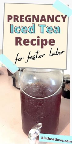 a jar filled with liquid sitting on top of a table next to a sign that says,