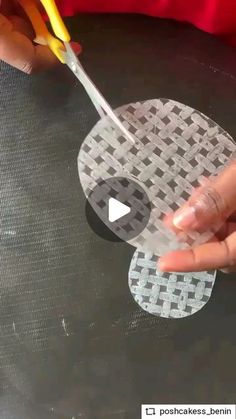 someone using scissors to cut out some paper circles