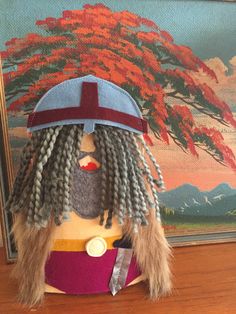 a stuffed animal wearing a hat with dreadlocks