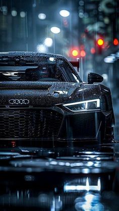 an audi sports car in the rain at night