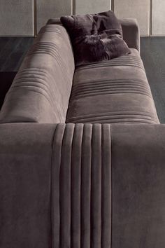 a large gray couch sitting on top of a hard wood floor