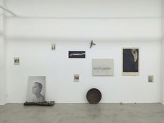 an empty room with paintings and sculptures on the wall