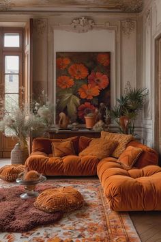 a living room with orange couches and rugs