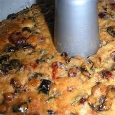 a close up of a pizza crust with olives and mushrooms on it next to a bottle