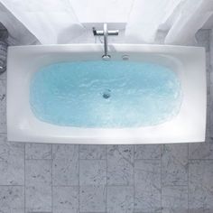 an overhead view of a bathtub with blue water