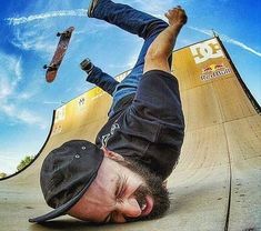 a skateboarder doing a trick on the side of a ramp with his feet in the air