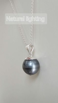 Free mini S925 name tag This platinum-gray Tahitian necklace is definitely a high-value choice. The pendant features a near-round Tahitian pearl with a diameter of 11.8-12mm. The surface  have some natural growth dots, but they are completely invisible from a normal social distance. The dark platinum-gray luster and tone also perfectly conceal any flaws. The main color of the pearl is a noble and elegant platinum gray, a highly sought-after color in Tahitian pearls, making it suitable for pairin Tahitian Pearl Necklace, Platinum Grey, June Birthstone, Tahitian Pearls, June Birth Stone, Tahiti, Cable Chain, Jewelry Necklace Pendant, Pearl Necklace