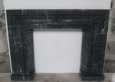 a black marble fireplace surround in a room