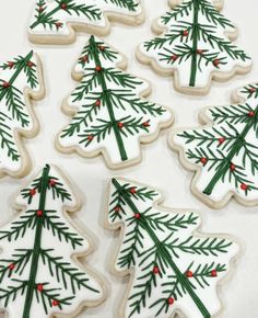 decorated cookies with green and red decorations on white tablecloth, christmas tree cookie toppers