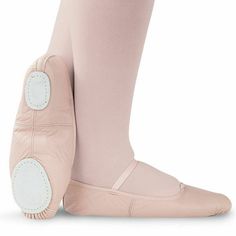 a pair of pink ballet shoes with white soles