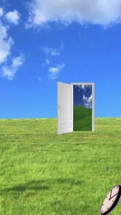 an open door in the middle of a grassy field