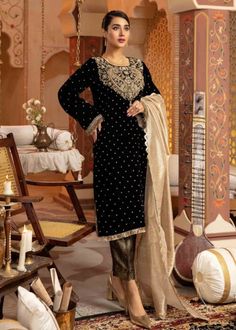 Experience sophistication with our beautifully crafted Velvet Black Straight Kurta featuring intricate Zardozi handwork. This ensemble is paired seamlessly with stylish Brocade Pants and adorned with a luxurious Golden Zari Dupatta, creating a striking and elegant look. Ideal for weddings, festive celebrations, and special events, making you stand out with elegance. A refined choice for the modern woman who appreciates a blend of cultural heritage and contemporary fashion. 💃 Style and Comfort: The designer ensemble is not just about style; it prioritizes comfort, allowing you to enjoy every moment of the celebration. Effortlessly transition from the ceremony to the dance floor in this versatile and comfortable attire. For any kind of customization i.e. fabric/color/style and size please m Black Velvet Shirt, Ladies Suit, Velvet Dress Designs, Velvet Shawl, Velvet Suit, Velvet Trousers, Velvet Shirt, Suit Designs, Wedding Wear