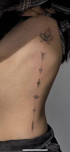 the back of a woman's stomach with flowers and butterflies on her lower side