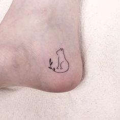 a small cat tattoo on the left side of the foot, which has an arrow pointing up to it's tail