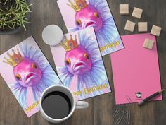 two greeting cards, one with a pink fish and the other with a crown on it