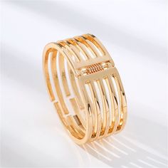 Add some polish to any ensemble with this 18k gold-plated bangle featuring a chic cutout design. 0.94" W x 2.36" diameter 18k gold-plated copper Gold Metal Rings For Spring, Modern Gold Bracelets For Spring, Trendy Gold Bangle For Spring, Spring Gold Trendy Bangle, Gold Bangle For Spring Gift, Gold Bracelet For Formal Occasions In Spring, Formal Gold Bracelet For Spring, Gold Open Ring Jewelry For Spring, Spring Gold Round Jewelry