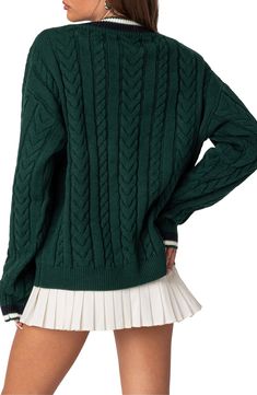 Classic cables and striped trim prep up this sweater knit from supersoft yarns in an oversized fit that layers over your tennis togs or anything else. V-neck Long sleeves with ribbed cuffs 100% Acrilan acrylic Hand wash, dry flat Imported Trendy Green Sweater With Ribbed Collar, Preppy Knit Sweater For Winter, Preppy Knit Sweater For Fall, Preppy College Sweater For Winter, Preppy Winter Sweater With Ribbed Collar, Preppy Sweater With Ribbed Cuffs For Fall, Green Knit Sweater With Ribbed Collar, Trendy Sweater With Ribbed Cuffs, Trendy College Sweater With Ribbed Cuffs